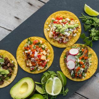 four flat corn tortillas with variety of taco bar ideas