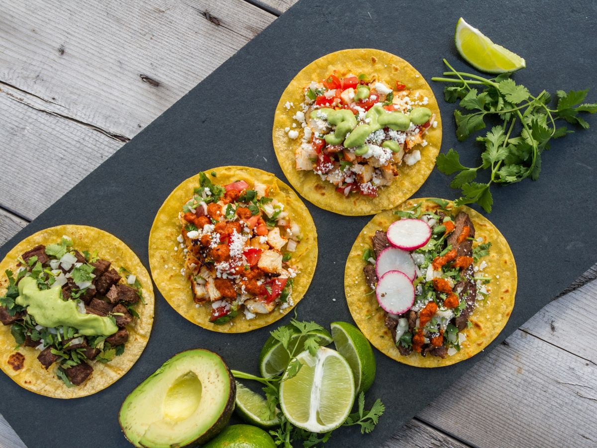 Four flat corn tortillas with variety of taco bar ideas.