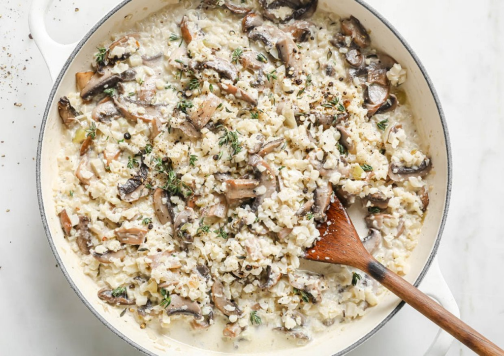 Recipe using frozen cauliflower rice in pot with wooden spoon.