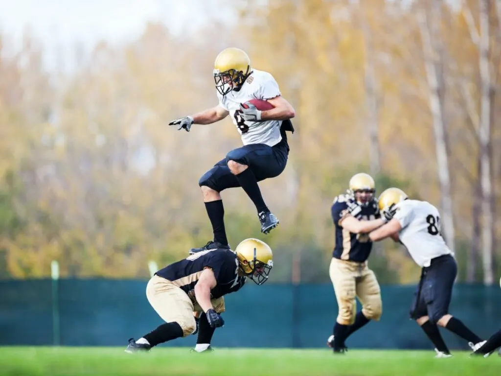 American football players in action on the playing field.