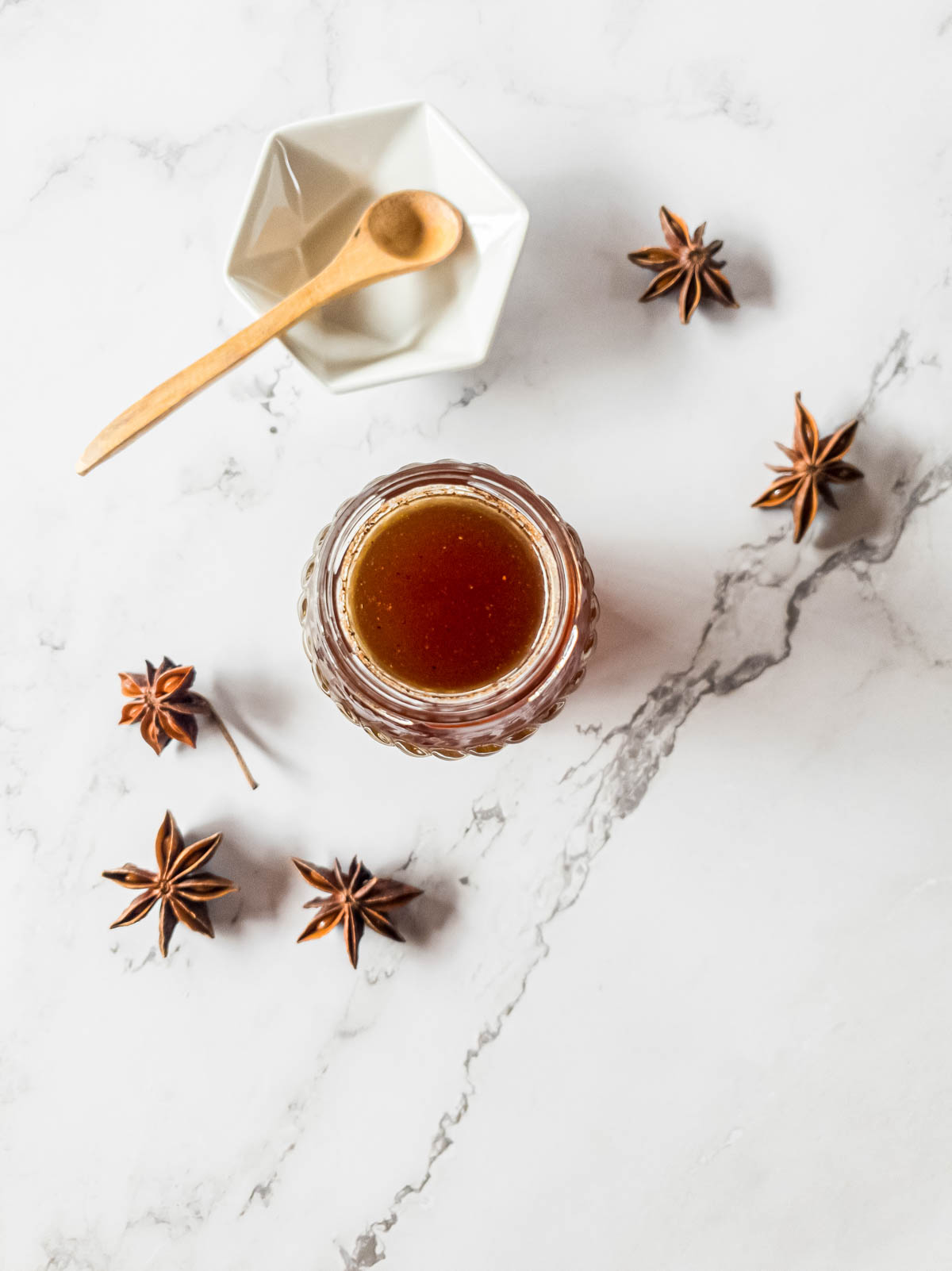 Chai tea syrup cooling on a white marble surface.