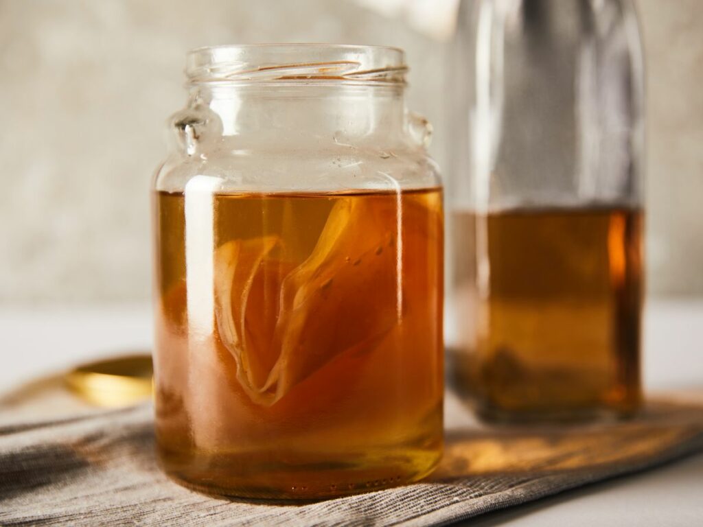 Kombucha scoby in open glass jar.