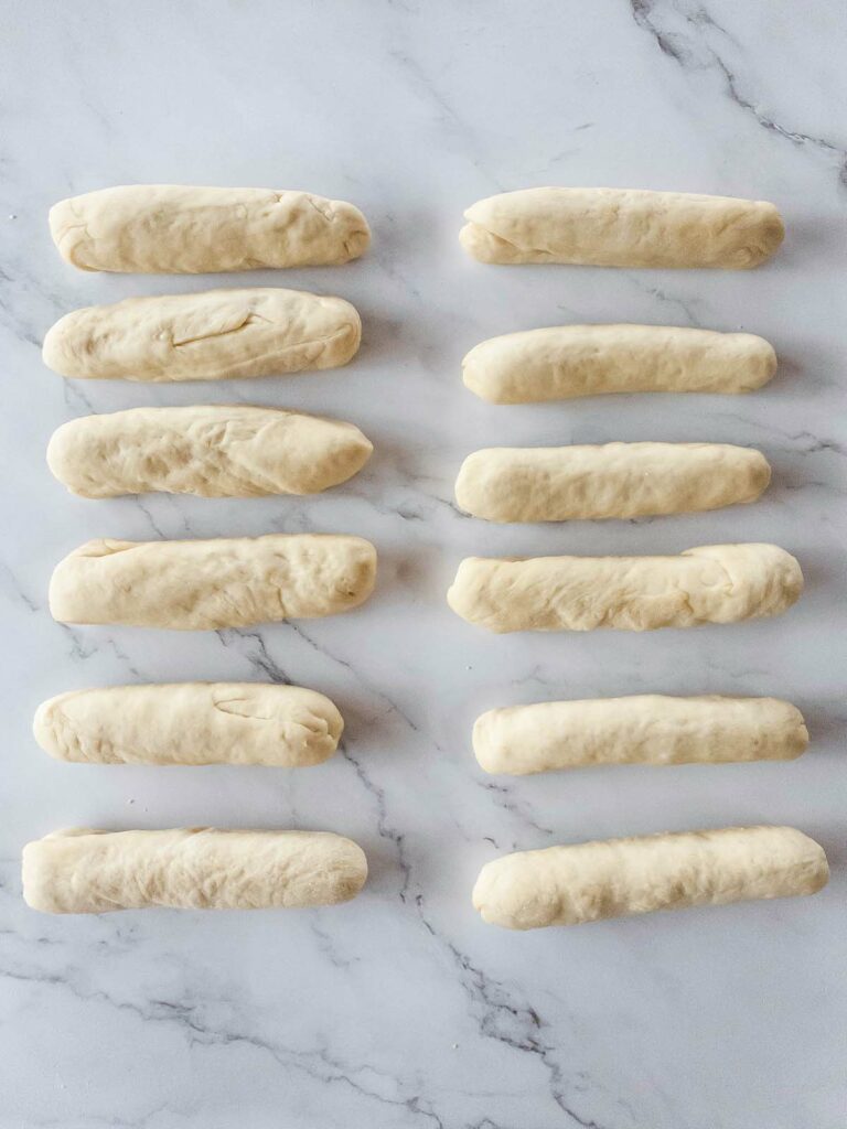 Jimmy John's bread shaped on marble countertop.