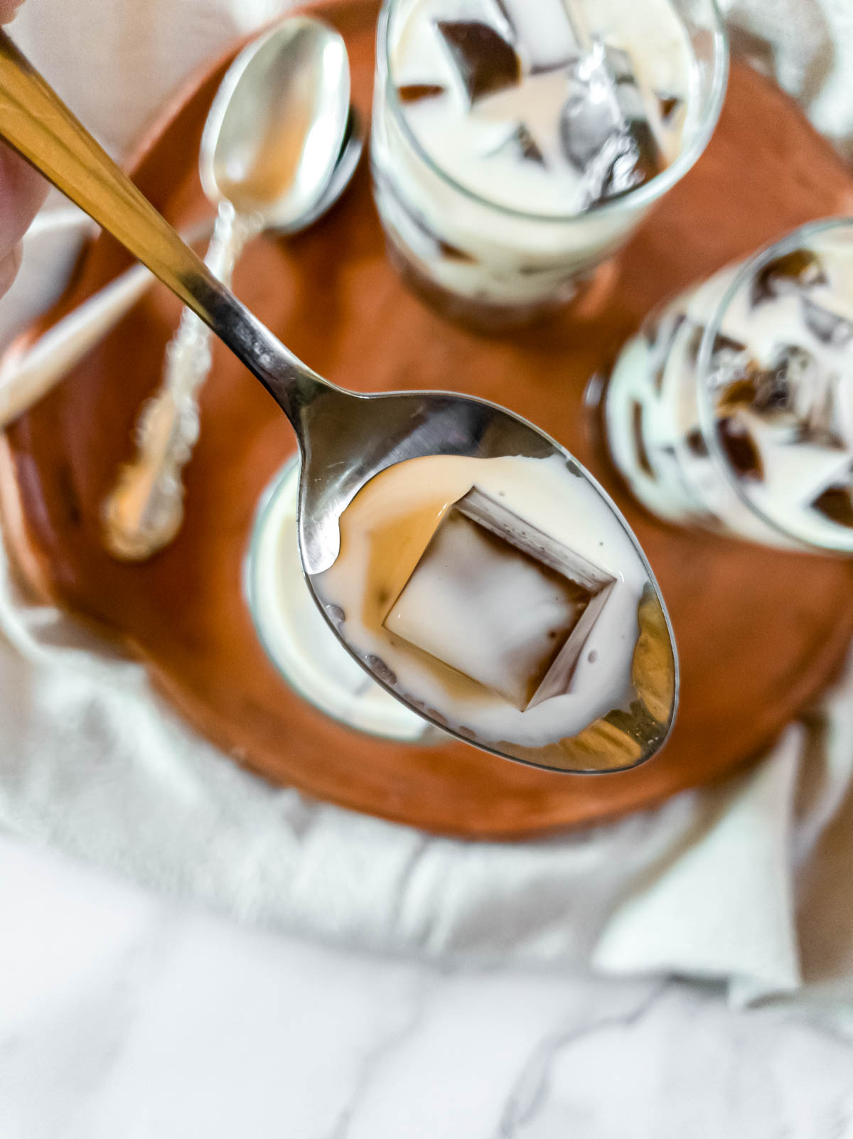 A copper spoon full of saiki k coffee jelly.