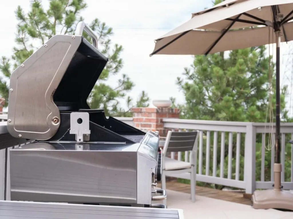 An open bbq grill on top of a deck.