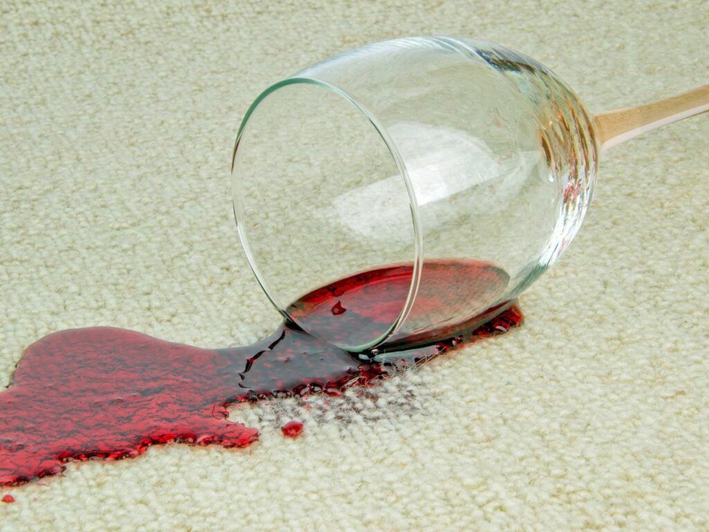 A red wine stain on a carpet and how to clean it.