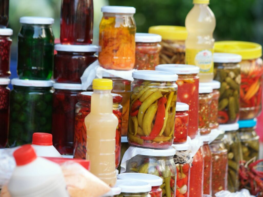 Many jars of pickles that can be used as an alternative to a rolling pin.