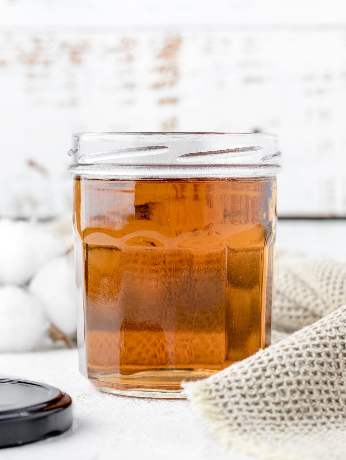 Honey in a jar on a wooden table.