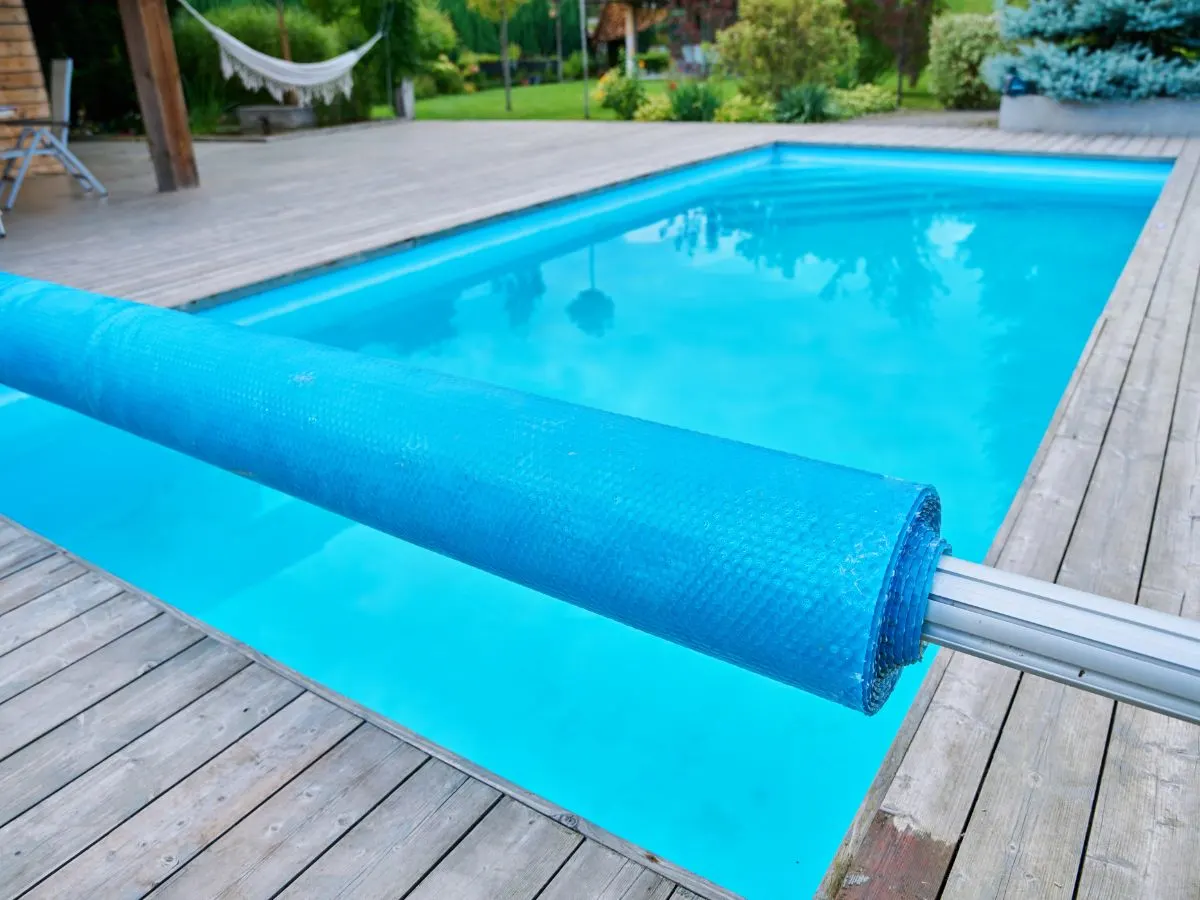 A pool with a blue cover attached to it.