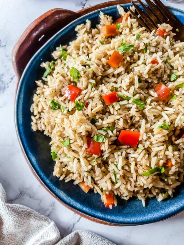 A blue plate with Longhorn steakhouse pilaf on it.