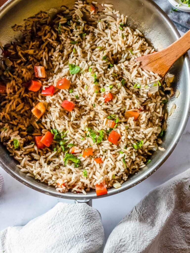 Rice in a pan with a wooden spatula.