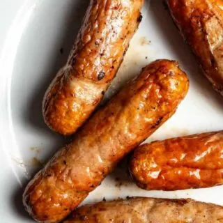 Sausages on a plate on a white plate.