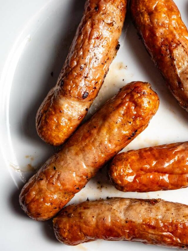 Sausages on a plate on a white plate.
