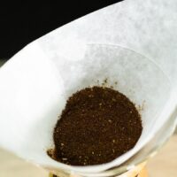 A coffee filter with coffee in it.