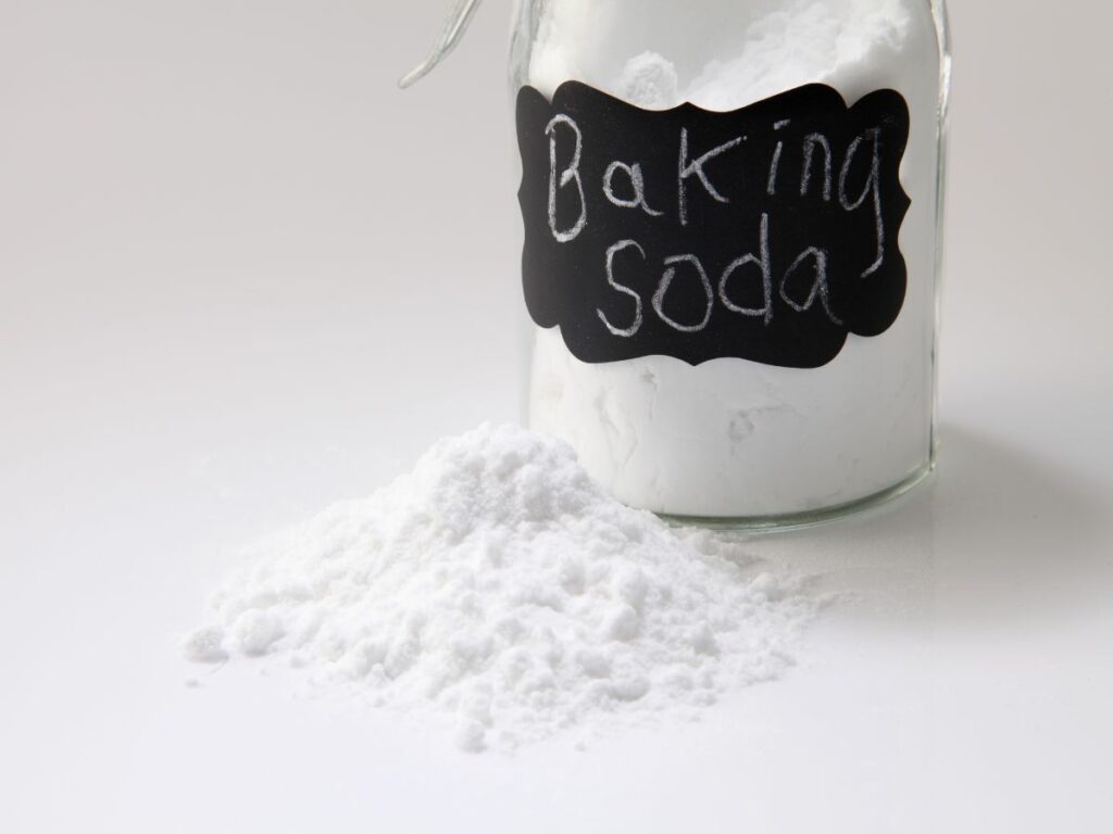 Baking soda in a jar on a white background.