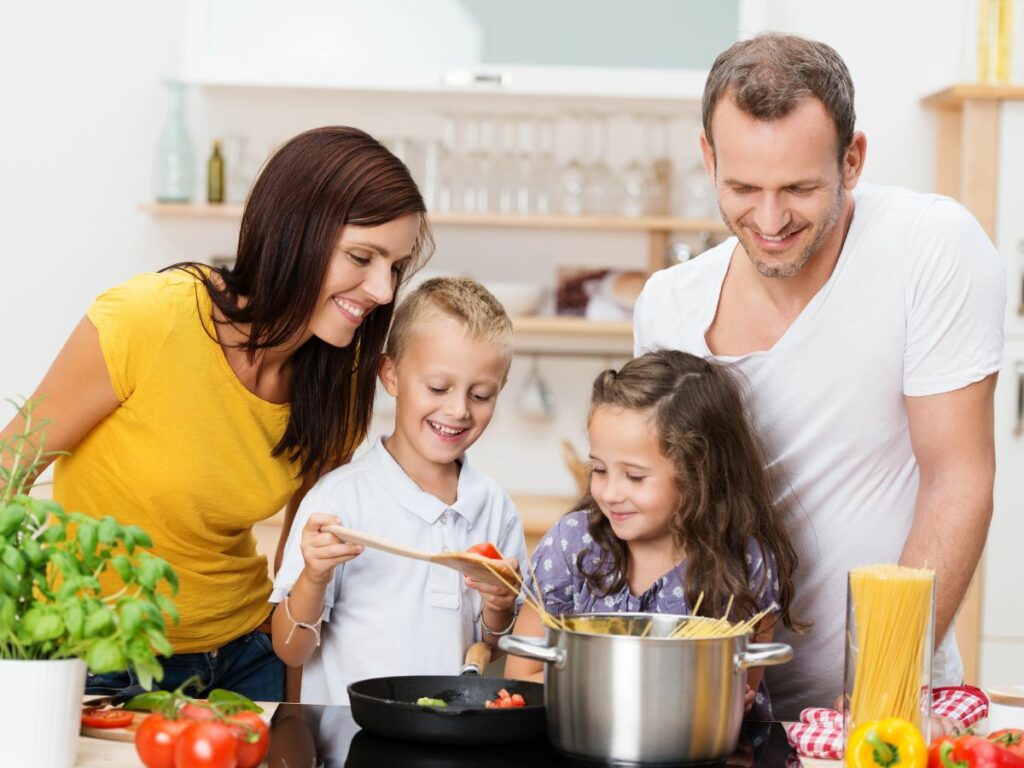 A family is cooking together in the kitchen.