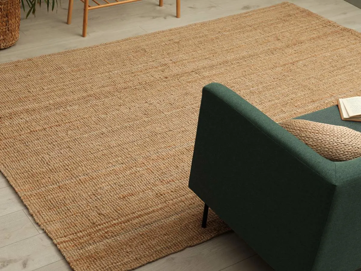 A carpet in a living room with a green chair.