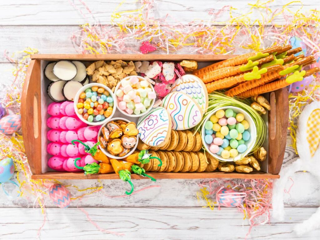 A wooden tray filled with easter treats.