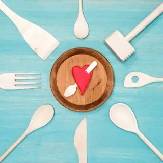 A plate of utensils with a heart on it.