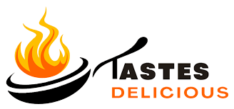 A logo showing a frying pan with flames above it and the text "Tastes Delicious" beside it.