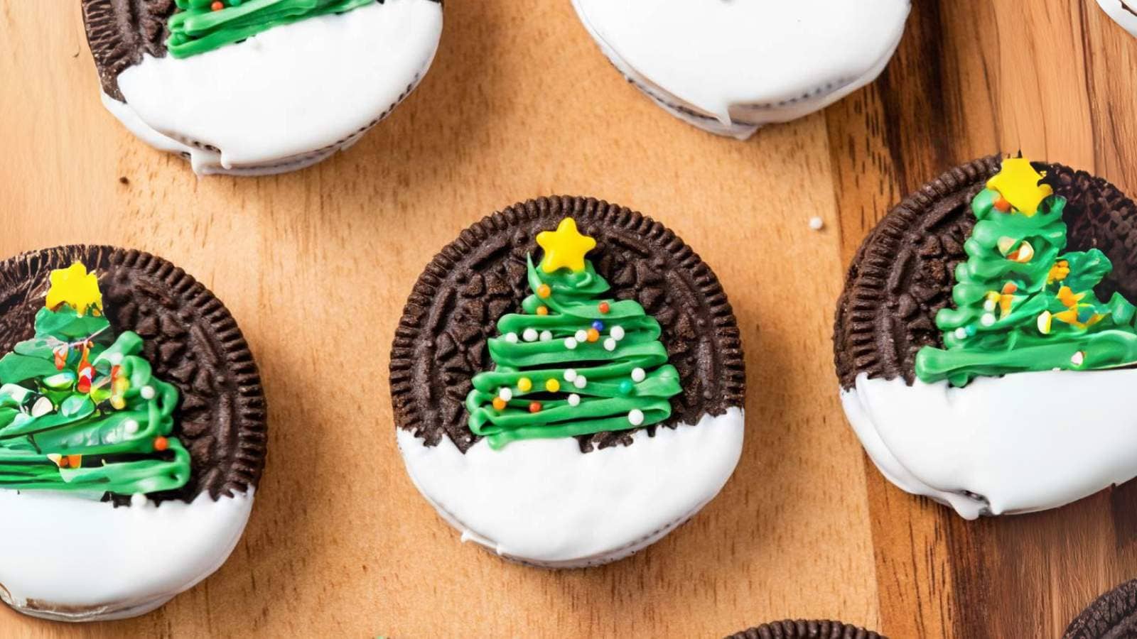 Christmas tree oreos decorated and placed on a wooden board.