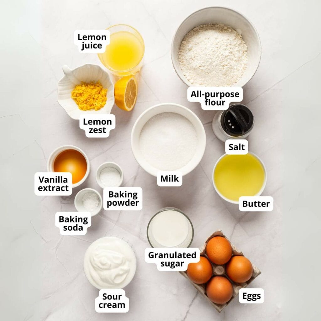 Ingredients for lemon loaf cake on a light colored surface.