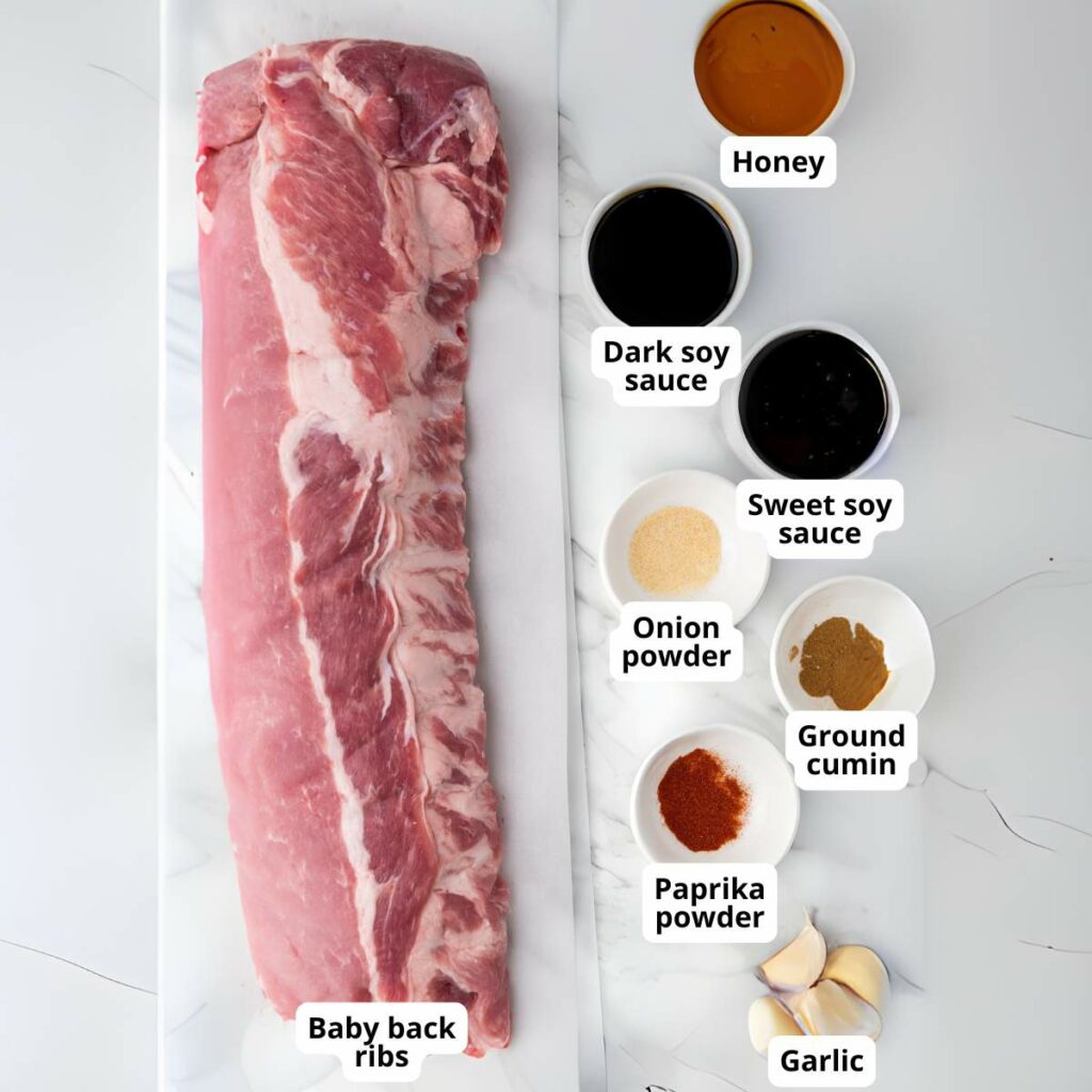 Ingredients for slow cooker baby back ribs on a light colored surface.