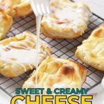 A fork drizzles icing over homemade cheese Danish pastries cooling on a wire rack, with text reading "Sweet & Creamy Cheese Danish.
