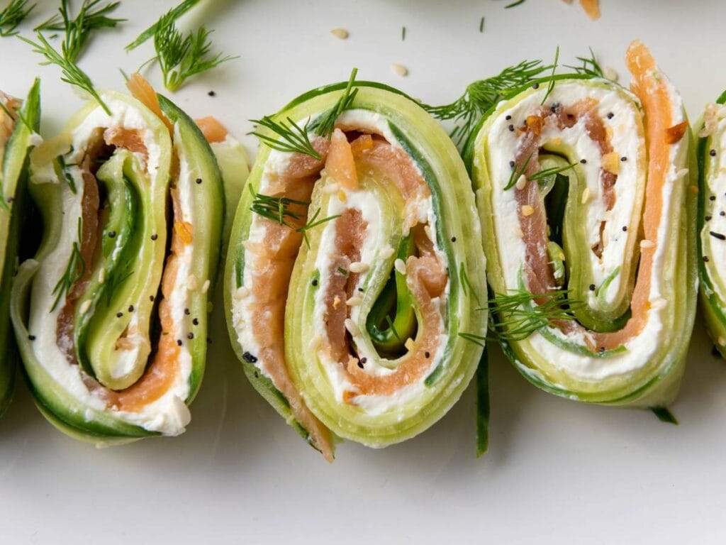 Close-up of cucumber pinwheels filled with cream cheese, smoked salmon, and dill.