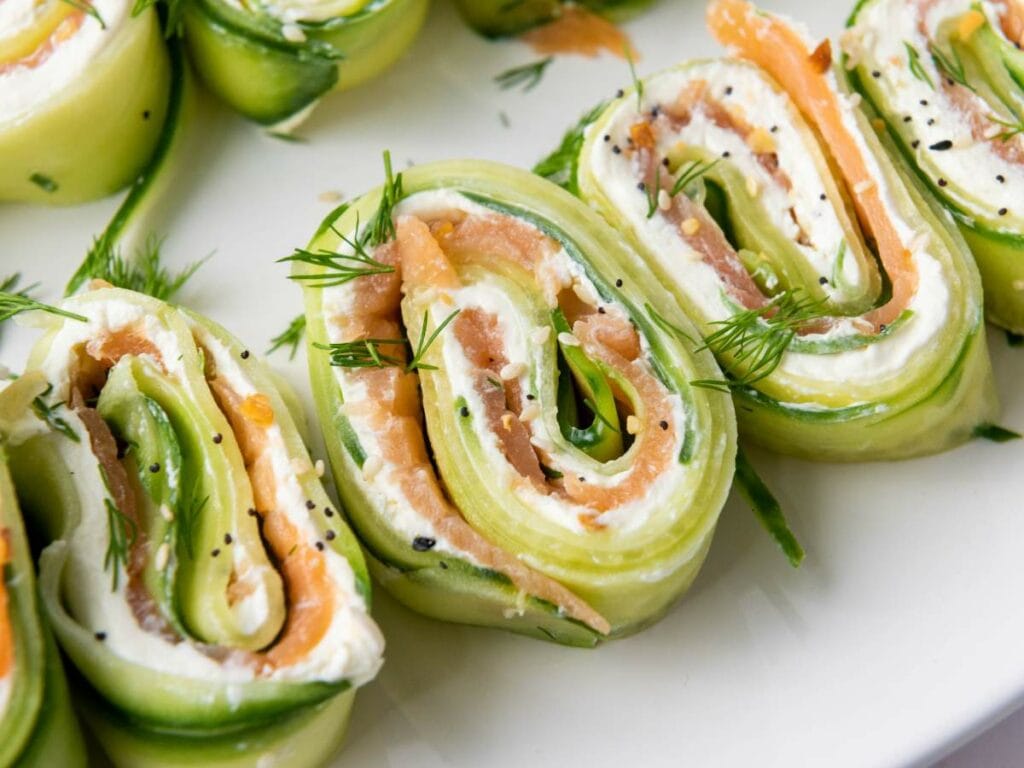 Close-up of cucumber pinwheels filled with cream cheese, smoked salmon, and fresh dill.