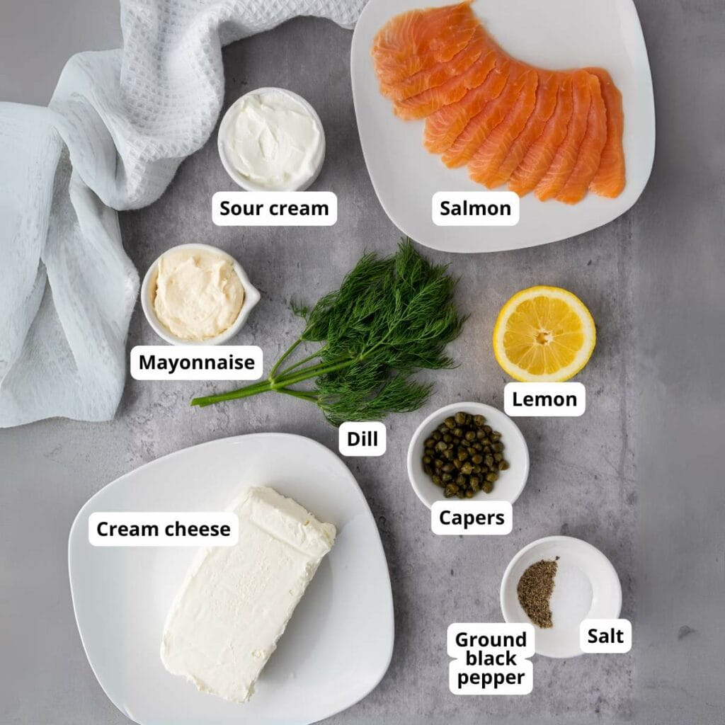 Ingredients for smoked salmon spread recipe arranged on a grey surface.