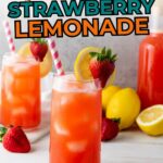 Two glasses of strawberry lemonade with ice, lemon slices, and strawberries, with a pitcher, lemons, and strawberries in the background.