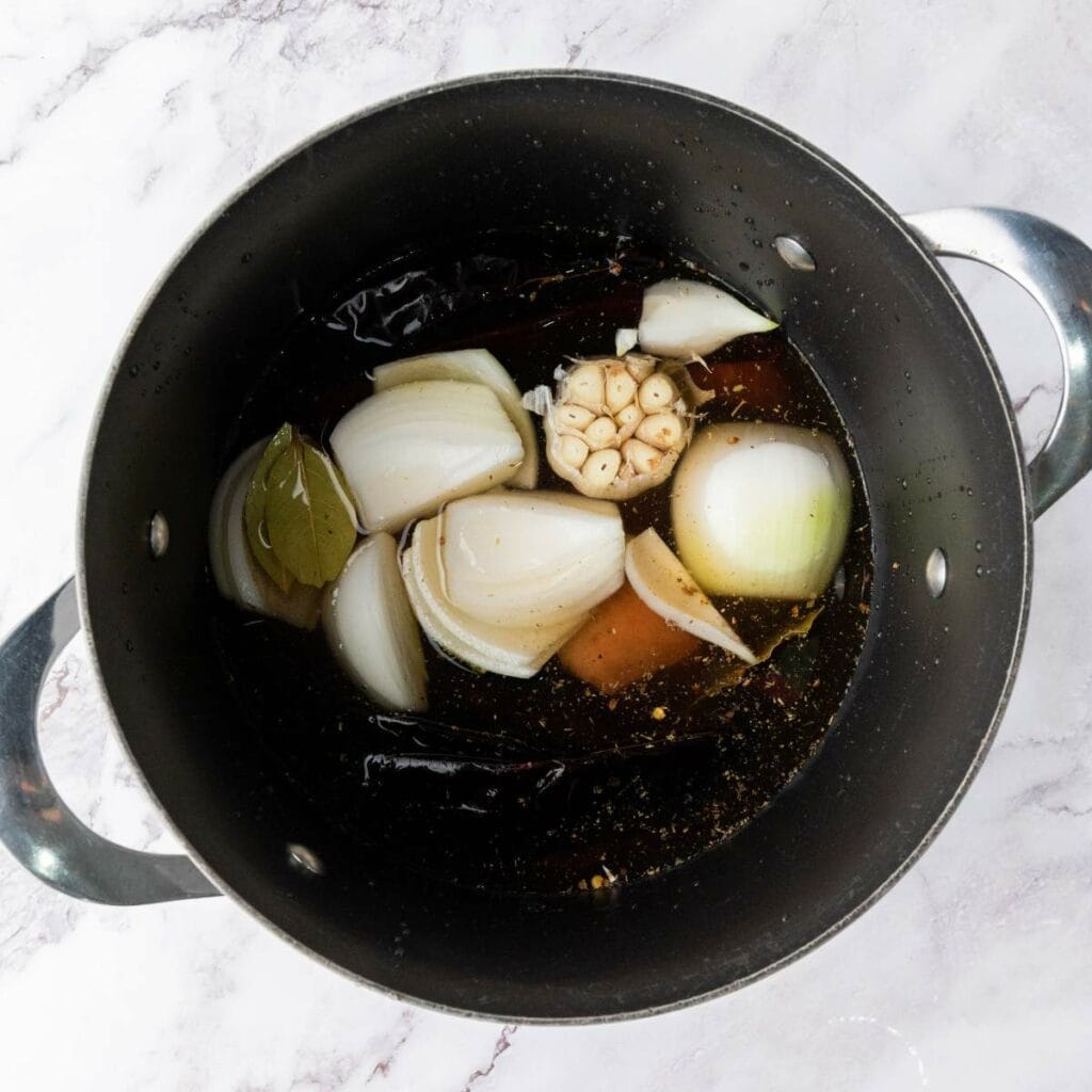 A large pot containing beef and spices.