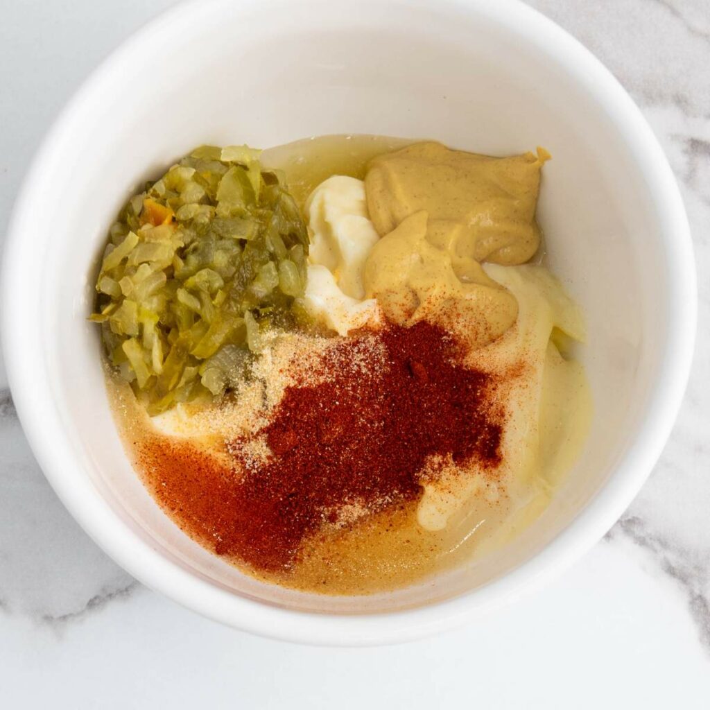 A white bowl containing seasonings.
