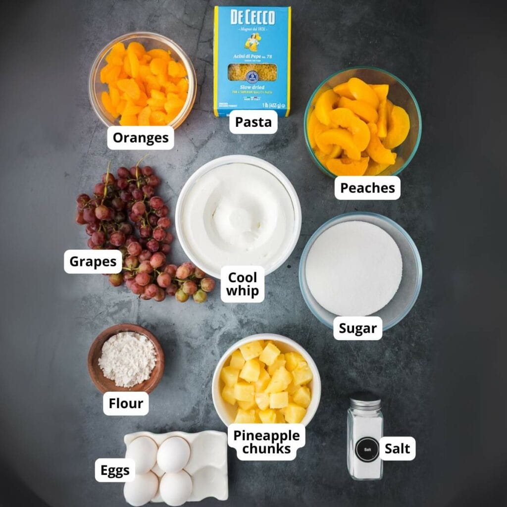 A flat lay of frog eye salad labeled ingredients on a dark surface.