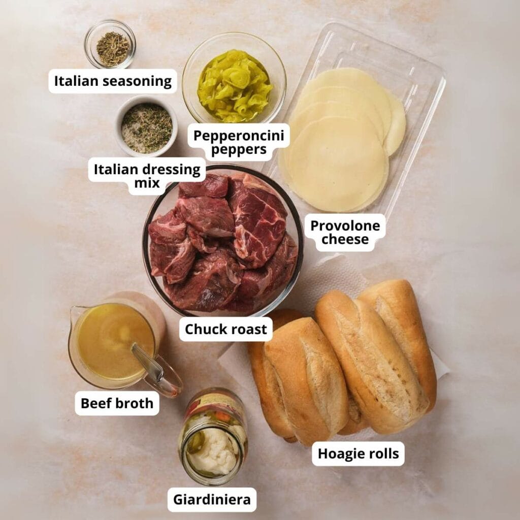 Top-down view of ingredients for a slow cooker italian beef on a light-colored surface.