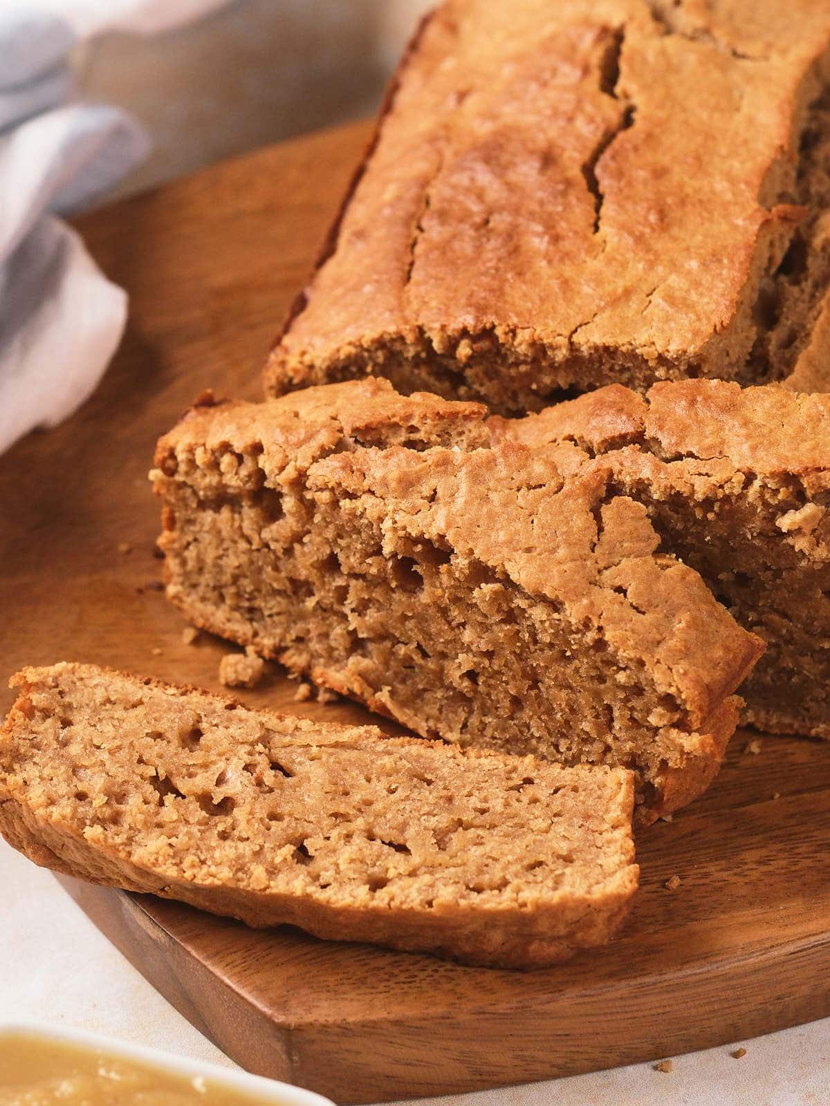 A close-up of sliced bread on a wooden cutting board.
