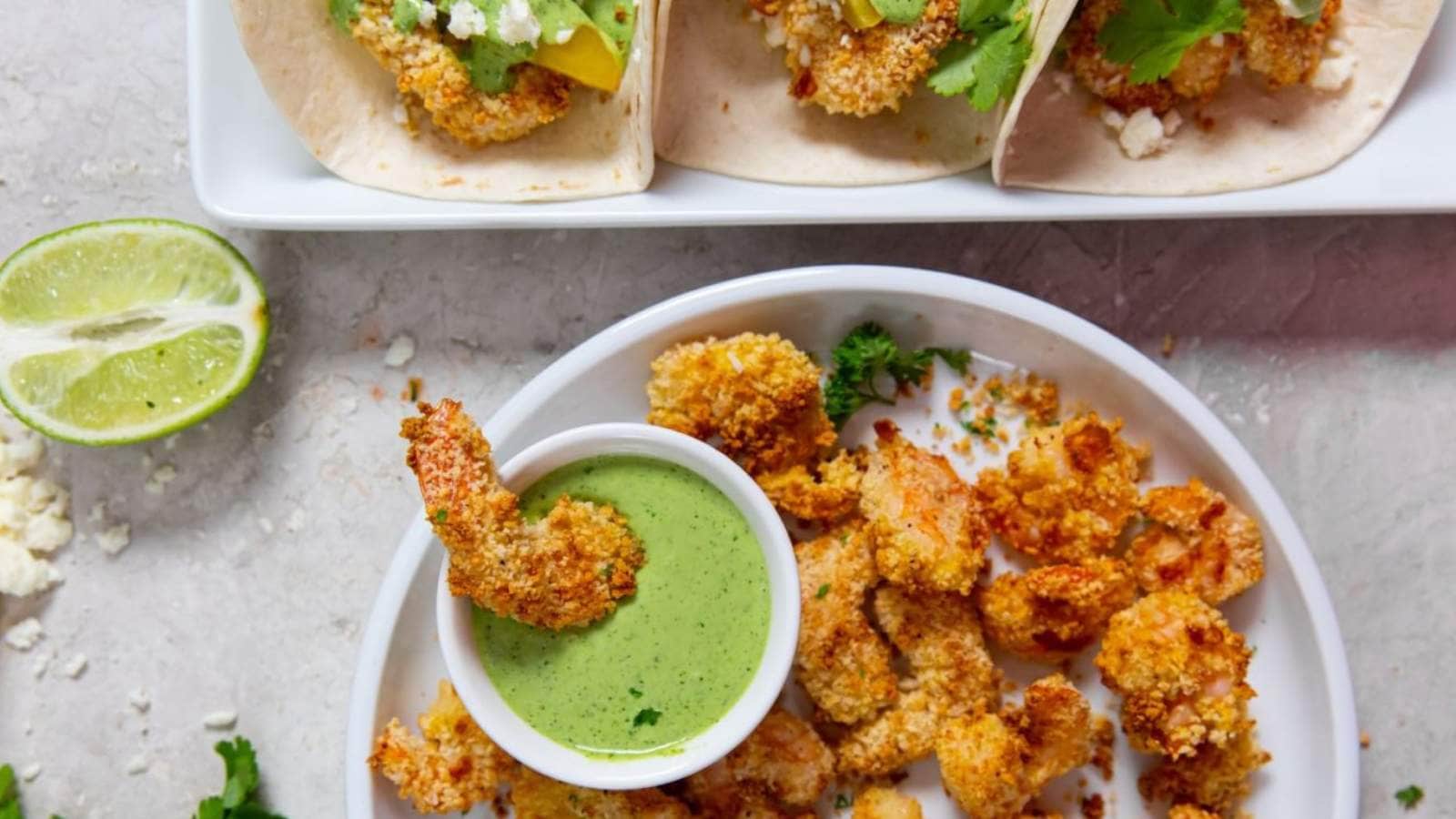 Air Fryer Panko Shrimp with cilantro lime dressing and parsley on a white plate.