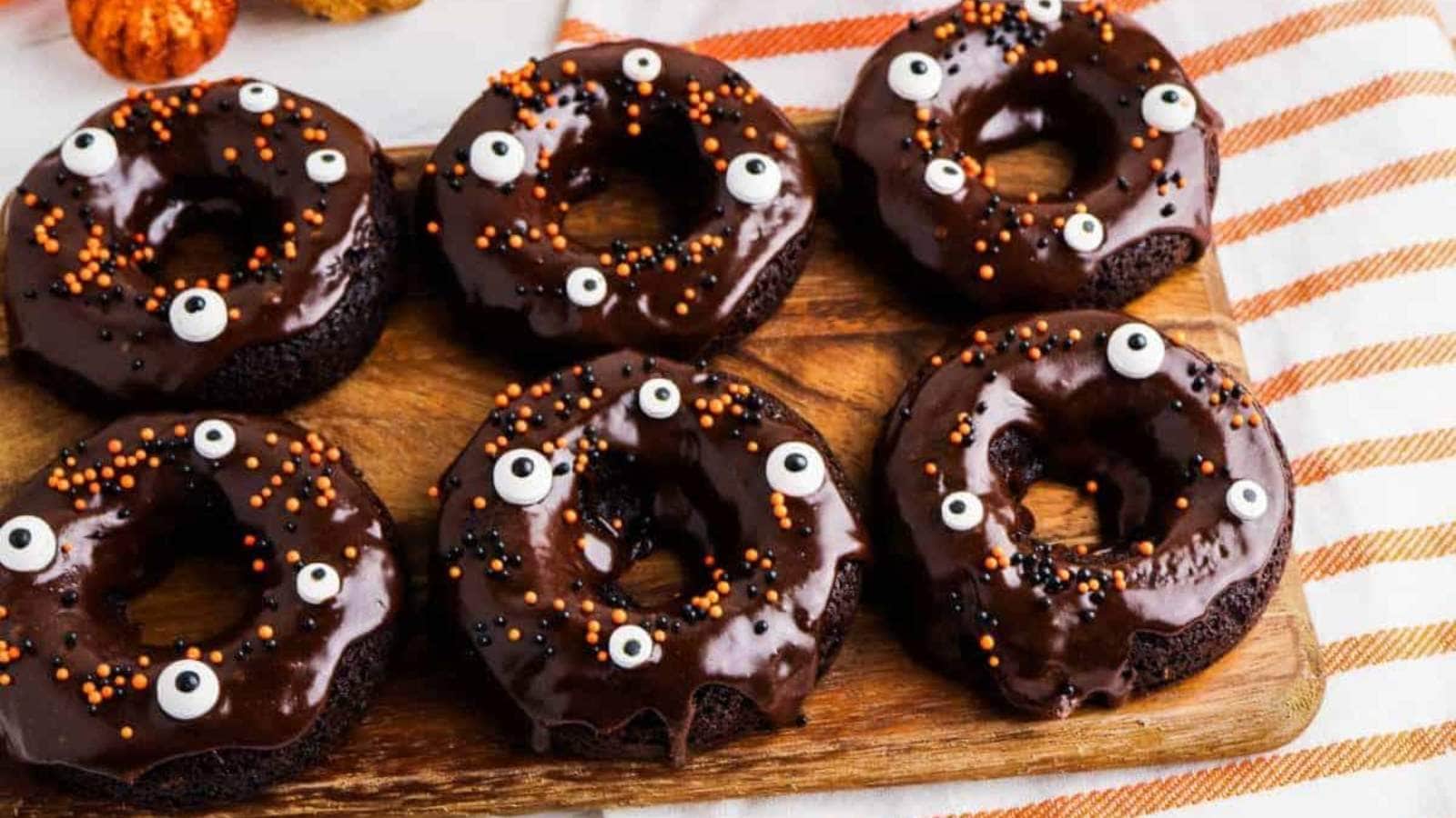 Chocolate Cake Mix Donuts decorated for halloween with frosting and sprinkles.