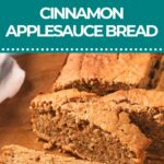 Sliced loaf of cinnamon applesauce bread on a wooden surface.