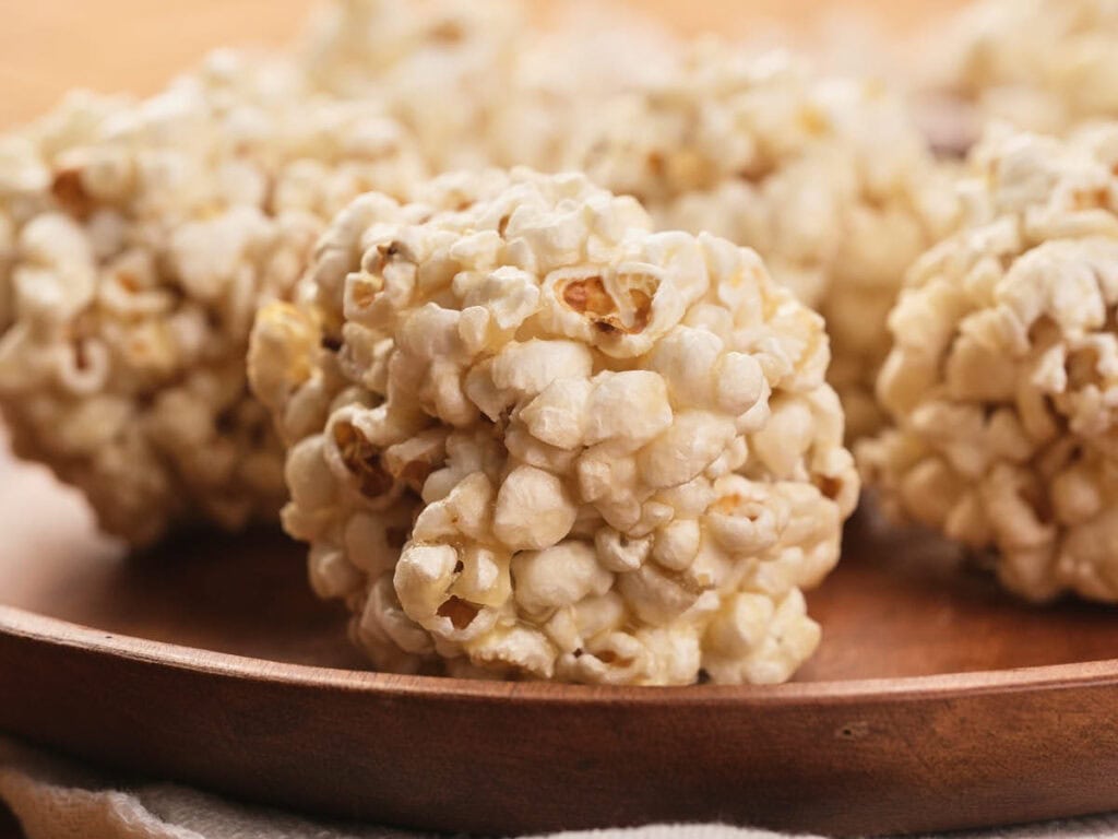 A plate of popcorn on a table.