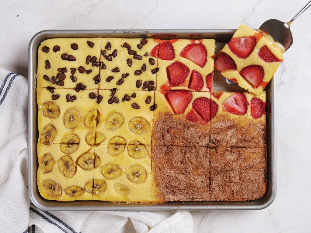 A rectangular baking tray with baked sheet pancakes, divided into four sections.