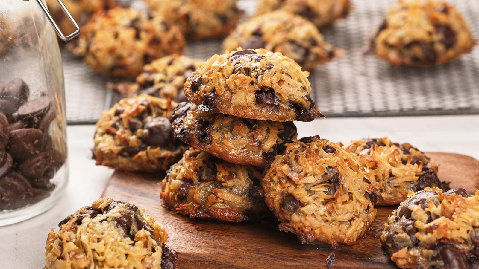 Magic cookies cooling on a black wire rack over a marble surface.