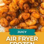 Cooked seasoned shrimp garnished with parsley and a lemon wedge, labeled “Juicy Air Fryer Frozen Shrimp” from Easy Homemade Life.
