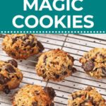 Six flourless cookies with chocolate chips and coconut on a cooling rack, shown under a sign reading “Flourless Magic Cookies.”.