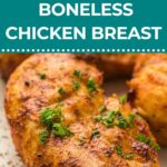 Cooked, seasoned boneless chicken breasts garnished with chopped herbs on a plate; text overlay reads “Air Fryer Boneless Chicken Breast.”.