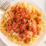 Mafaldine pasta topped with chicken and a chunky tomato sauce.