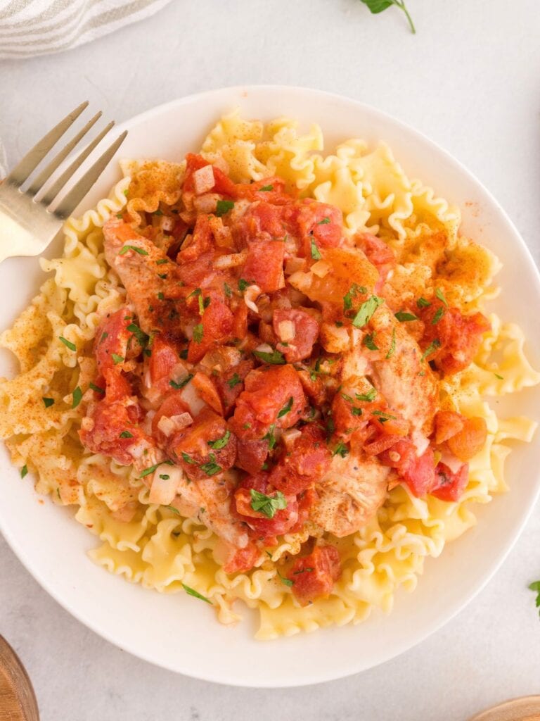 Mafaldine pasta topped with chicken and a chunky tomato sauce.