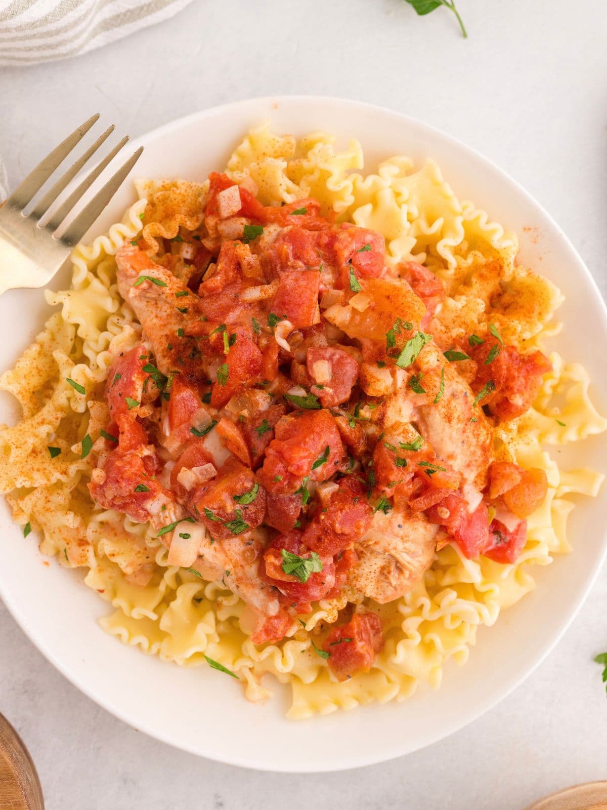 Mafaldine pasta topped with chicken and a chunky tomato sauce.